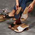 Women's floral cut-out mules—open-toe, slip-on sandals featuring a platform and block heel.